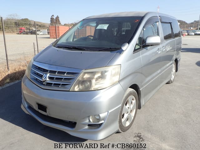 A grey JDM sports car speeding down a highway at night.
