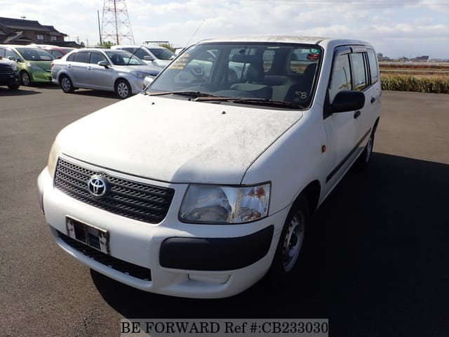 A grey JDM sports car speeding down a highway at night.