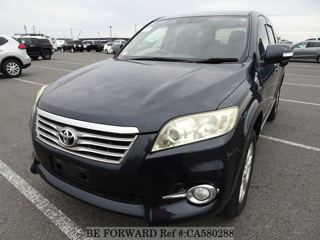 A grey JDM sports car speeding down a highway at night.