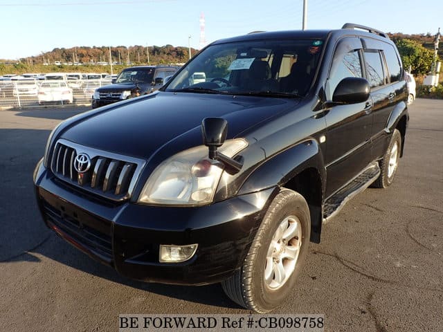 A grey JDM sports car speeding down a highway at night.
