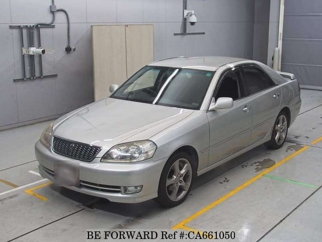 A grey JDM sports car speeding down a highway at night.