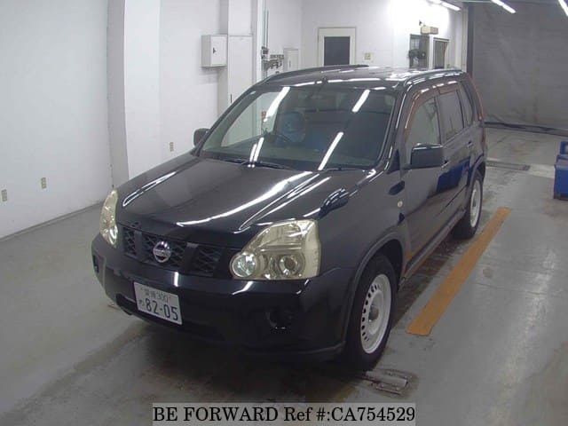 A grey JDM sports car speeding down a highway at night.
