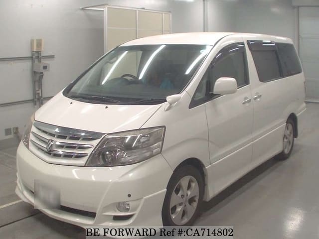 A grey JDM sports car speeding down a highway at night.