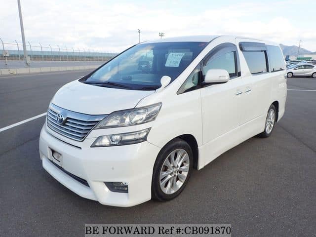 A grey JDM sports car speeding down a highway at night.