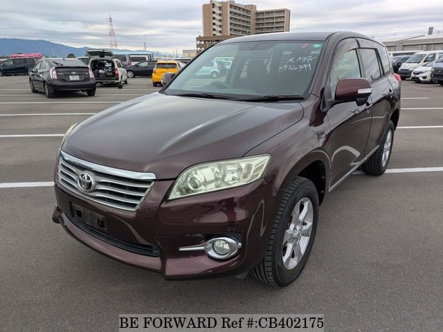 A grey JDM sports car speeding down a highway at night.