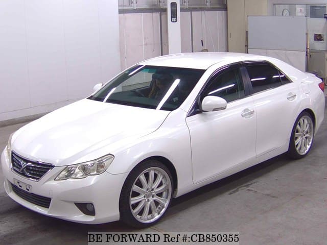 A grey JDM sports car speeding down a highway at night.