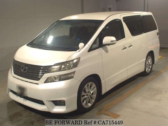 A grey JDM sports car speeding down a highway at night.