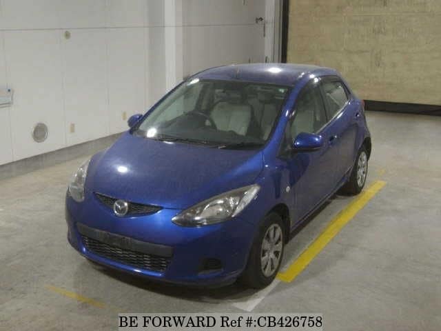 A grey JDM sports car speeding down a highway at night.