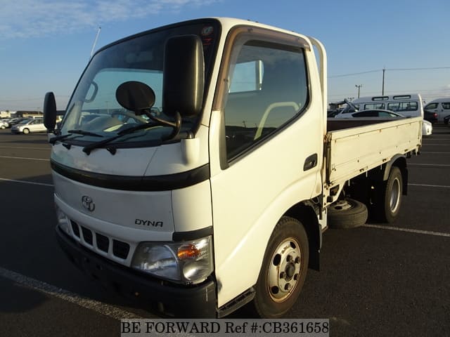 A grey JDM sports car speeding down a highway at night.