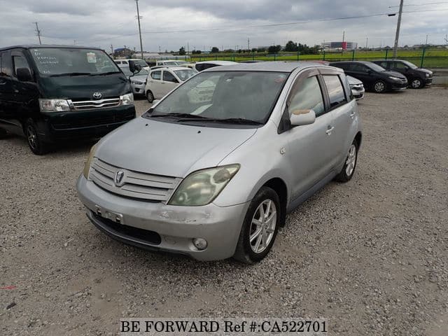 A grey JDM sports car speeding down a highway at night.