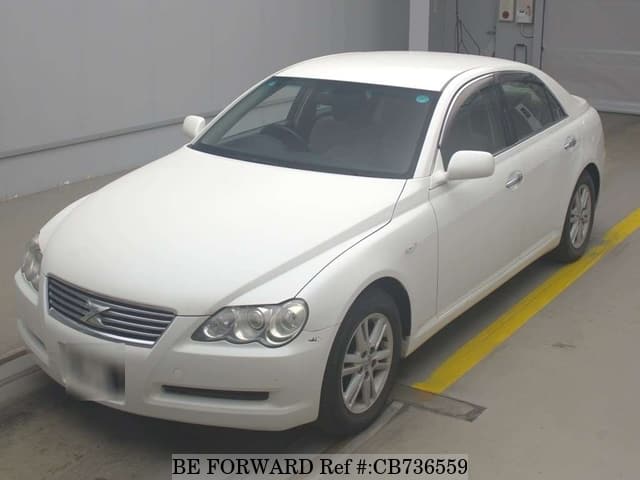 A grey JDM sports car speeding down a highway at night.