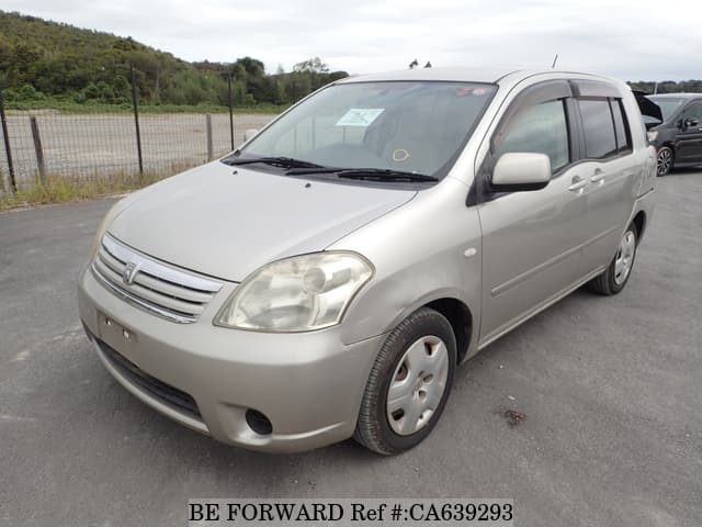 A grey JDM sports car speeding down a highway at night.