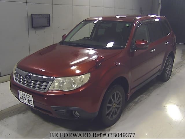 A grey JDM sports car speeding down a highway at night.