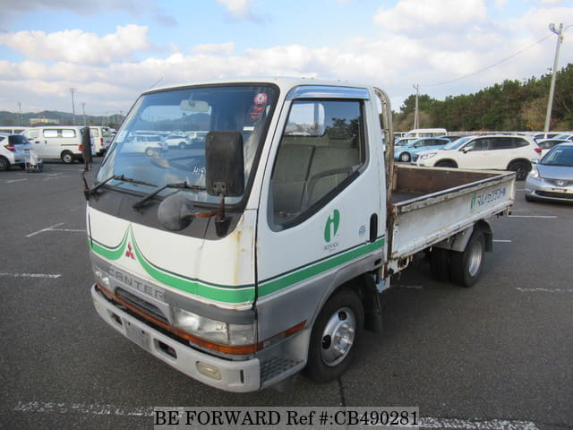 A grey JDM sports car speeding down a highway at night.