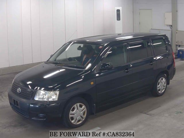 A grey JDM sports car speeding down a highway at night.