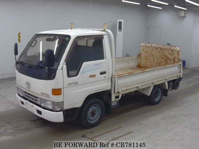 A grey JDM sports car speeding down a highway at night.