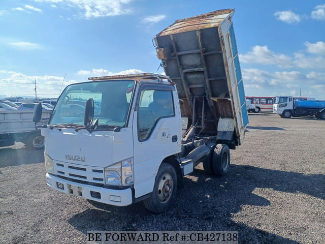 A grey JDM sports car speeding down a highway at night.