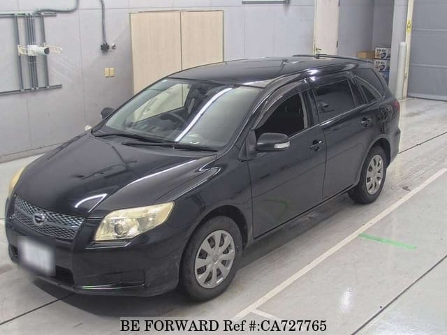 A grey JDM sports car speeding down a highway at night.