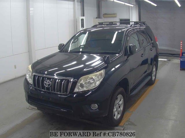 A grey JDM sports car speeding down a highway at night.