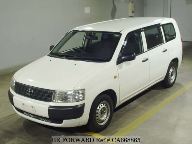 A grey JDM sports car speeding down a highway at night.