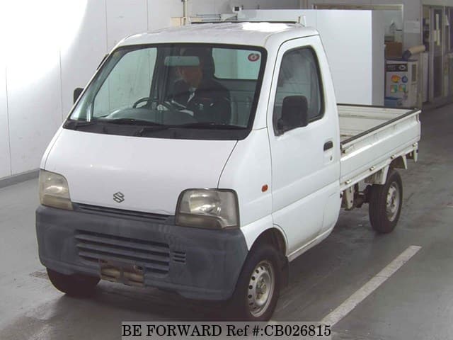 A grey JDM sports car speeding down a highway at night.