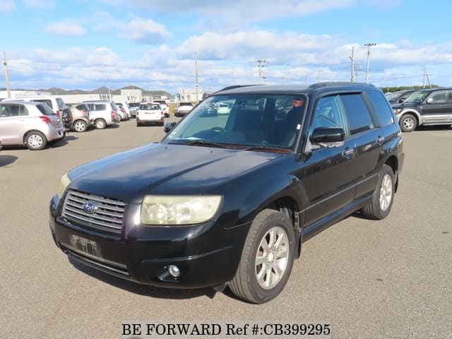 A grey JDM sports car speeding down a highway at night.