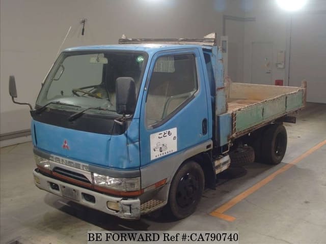 A grey JDM sports car speeding down a highway at night.