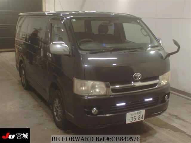 A grey JDM sports car speeding down a highway at night.