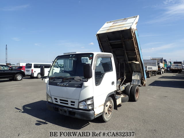 A grey JDM sports car speeding down a highway at night.