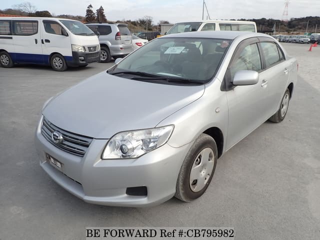 A grey JDM sports car speeding down a highway at night.