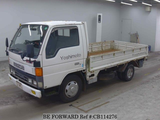 A grey JDM sports car speeding down a highway at night.