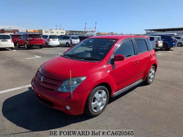 A grey JDM sports car speeding down a highway at night.