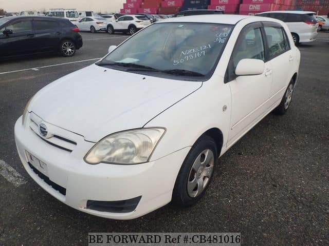 A grey JDM sports car speeding down a highway at night.