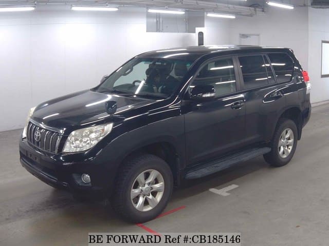 A grey JDM sports car speeding down a highway at night.