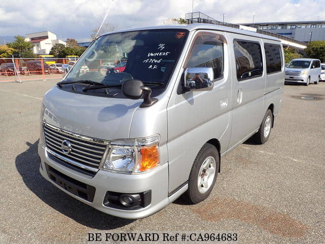 A grey JDM sports car speeding down a highway at night.