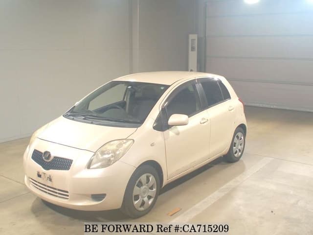 A grey JDM sports car speeding down a highway at night.