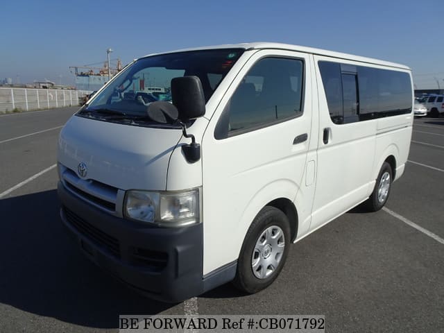 A grey JDM sports car speeding down a highway at night.