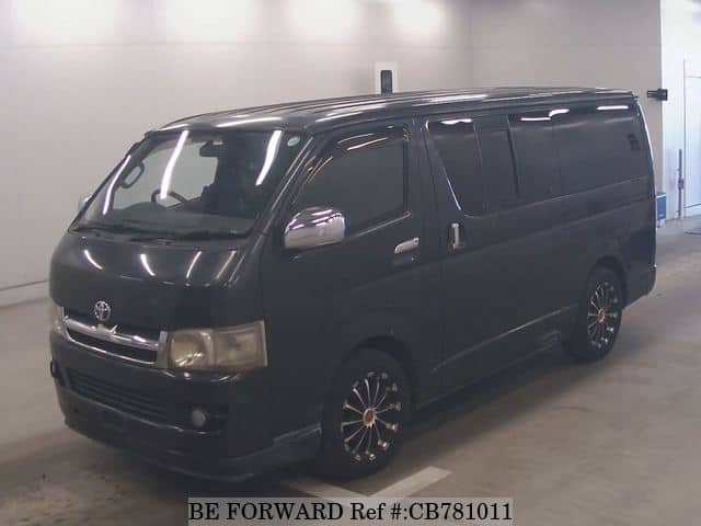 A grey JDM sports car speeding down a highway at night.