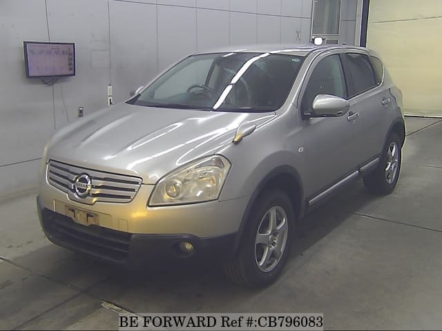 A grey JDM sports car speeding down a highway at night.