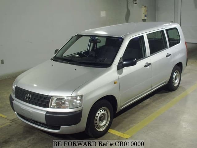 A grey JDM sports car speeding down a highway at night.
