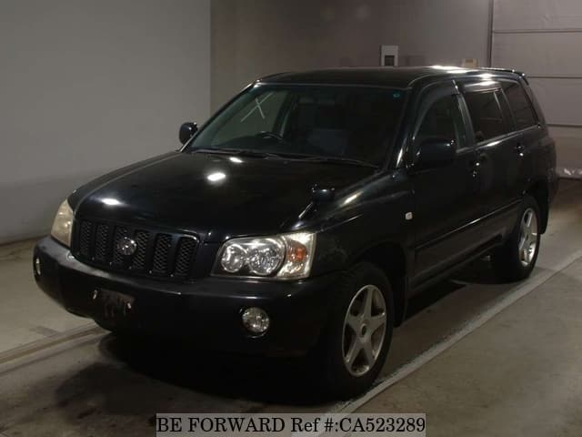A grey JDM sports car speeding down a highway at night.