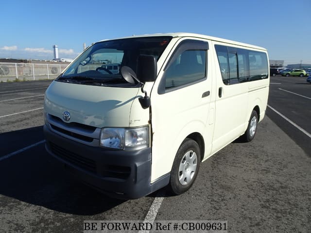 A grey JDM sports car speeding down a highway at night.