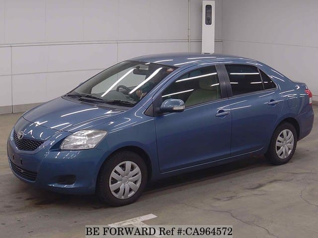 A grey JDM sports car speeding down a highway at night.
