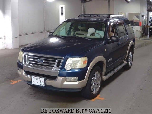 A grey JDM sports car speeding down a highway at night.