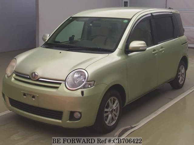 A grey JDM sports car speeding down a highway at night.