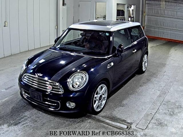 A grey JDM sports car speeding down a highway at night.