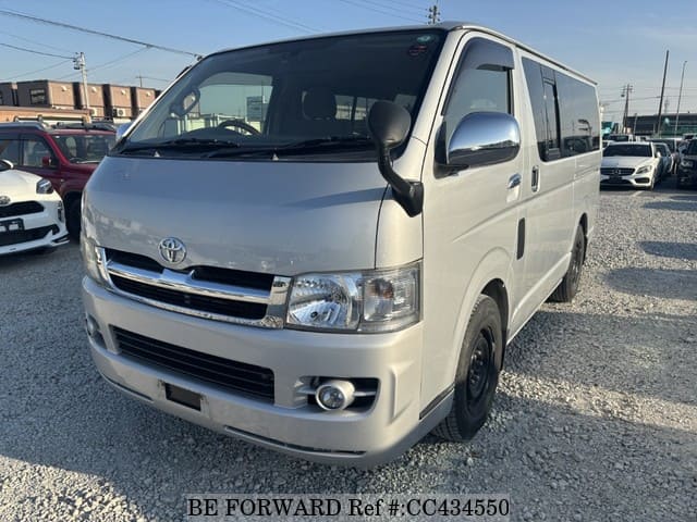 A grey JDM sports car speeding down a highway at night.