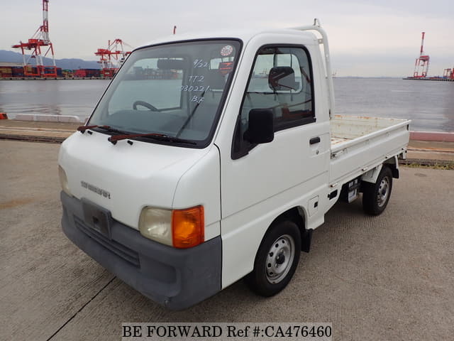 A grey JDM sports car speeding down a highway at night.