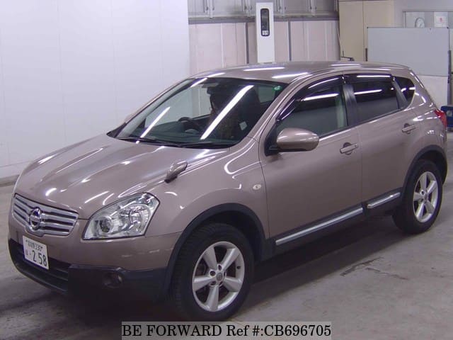 A grey JDM sports car speeding down a highway at night.