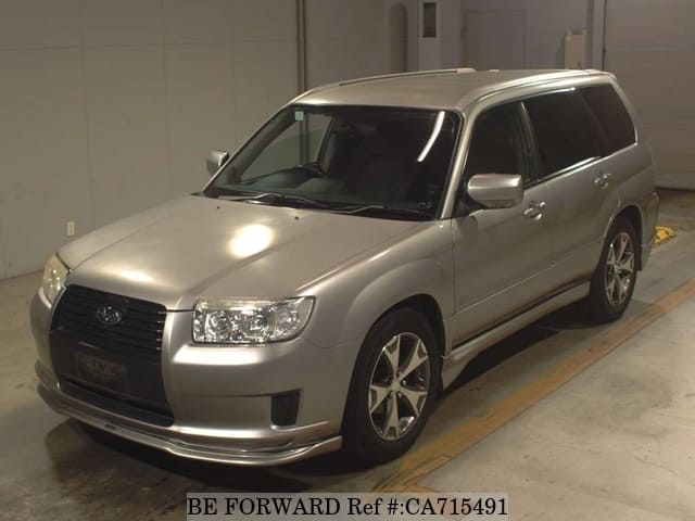 A grey JDM sports car speeding down a highway at night.